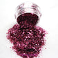 This glitter is called Pinky Swear and is part of the super chunky glitter collection. It consists of magenta glitter with a holographic sparkle.  Pinky Swear can be used for your face, body, hair and nails. Comes in 5g jars only.