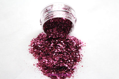 This glitter is called Pinky Swear and is part of the super chunky glitter collection. It consists of magenta glitter with a holographic sparkle.  Pinky Swear can be used for your face, body, hair and nails. Comes in 5g jars only.