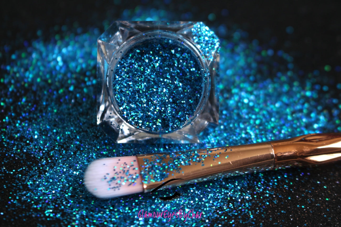 This glitter is called Poolside and is part of the simple glitter collection. It consists of caribbean sea blue glitter with a holographic sparkle.  Poolside can be used for your face, body, hair and nails. Comes in 5g jars only.