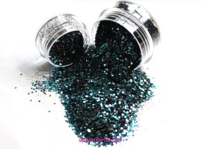 This glitter is called Pure Poison and is part of the chunky glitter collection. It consists of black holographic glitter with a teal and aqua sparkle. Pure Poison can be used for your face, body, hair and nails.  Comes in 5g and 10g jars. **Glitter will be discontinued once sold out**