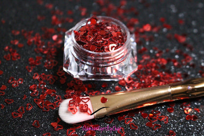 This glitter is called Red Hearts and is part of the shaped glitters collection. It consists of ruby red solid and hollow hearts. Red Hearts can be used for body and nail art or DIY projects. Comes in 5g jars only.