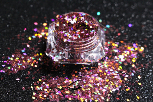 This glitter is called Rose Pink Diamonds and is part of the shaped glitters collection. It consists of rose pink diamond glitter with a dazzling holographic sparkle. Rose Pink Diamonds can be used for your face, body, hair and nails.