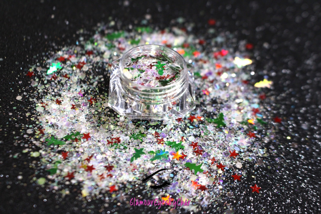 This glitter is called Santa's Grotto and is part of the holiday collection.  It consists of white and silver glitter with green Christmas trees and red stars. Santa's Grotto can be used for your face, body, hair and nails.  Comes in 5g jars only.  