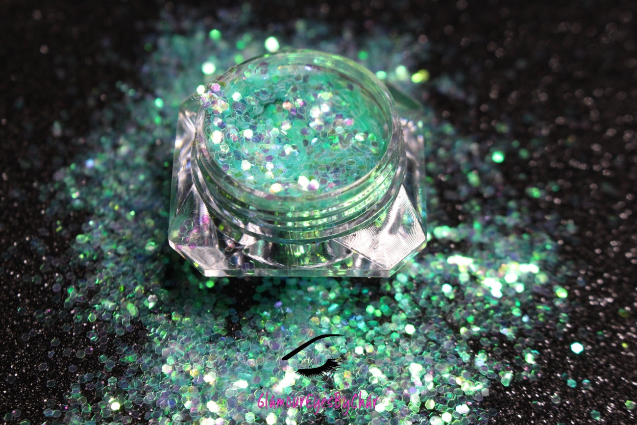This glitter is called Sea Me and is part of the simple glitter collection. It consists of aqua green glitter with an iridescent sparkle. Flake size is larger than fine and extra fine glitter. Sea Me can be used for your face, body, hair and nails.