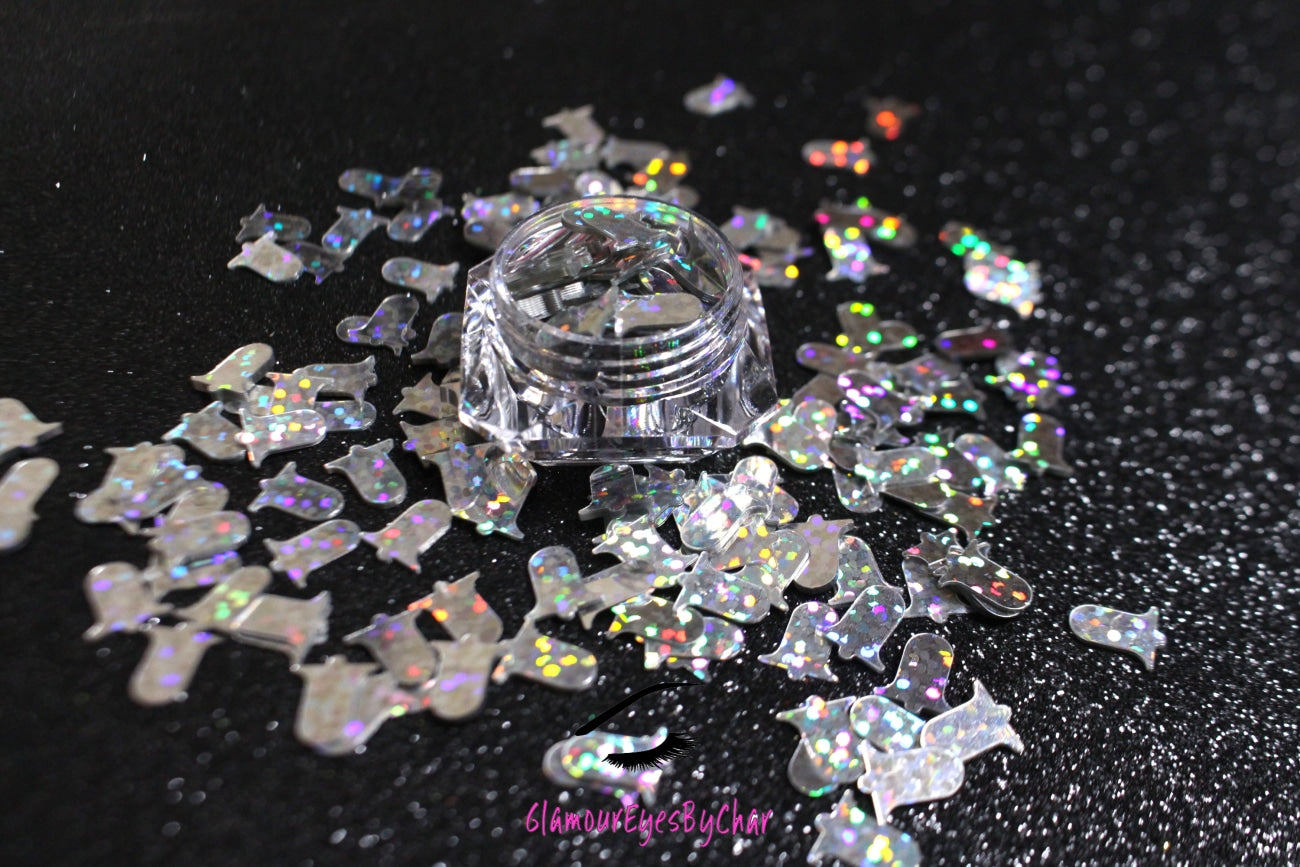 This glitter is called Silver Bells and is part of the holiday collection.  It consists of holographic silver 10mm bells. Silver Bells can be used for body art and DIY projects.  Comes in 5g jars only.  